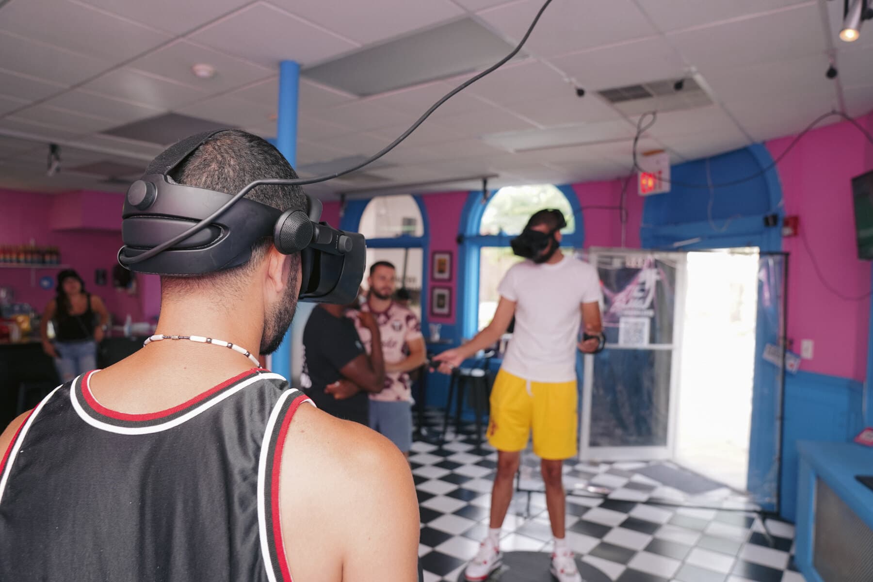 Several people in VR headsets playing together on the floor of The Bubbler VR venue in Providence